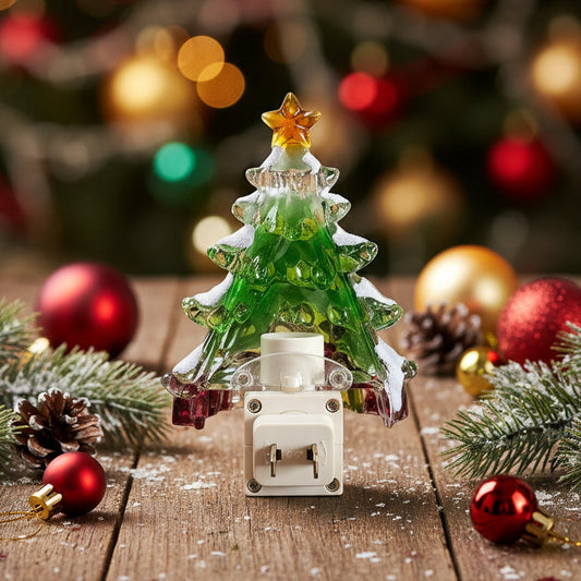 Decorative Christmas tree ornament on a wooden surface with a blurred Christmas tree in the background.