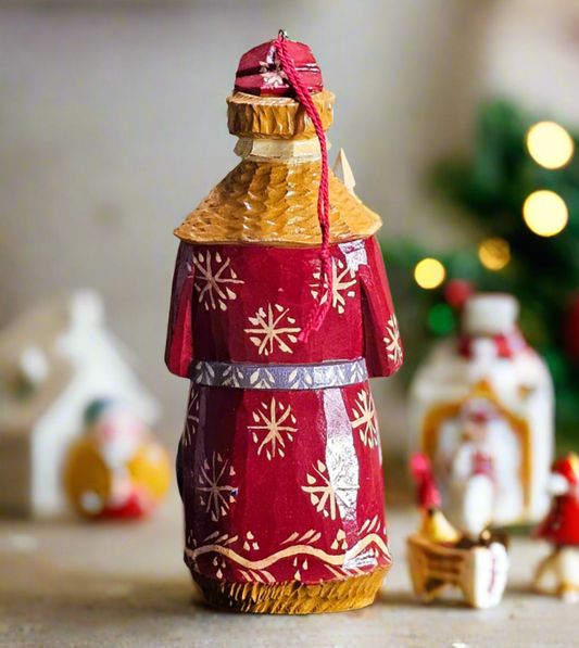 Decorative bottle with a red and gold top, placed on a surface with a blurred festive background.