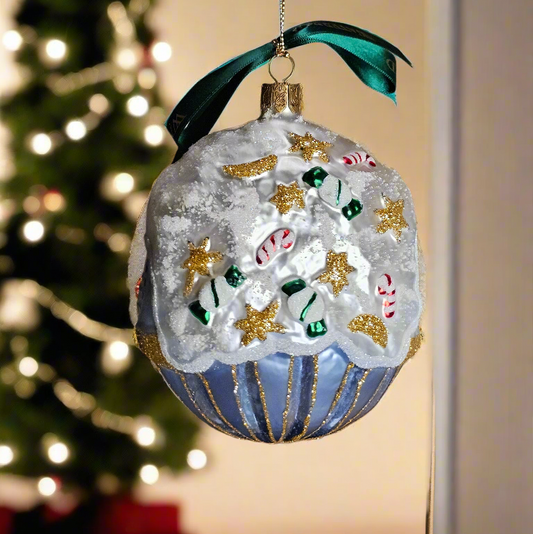 Decorative Christmas ornament with candy cane design on a blurred Christmas tree background